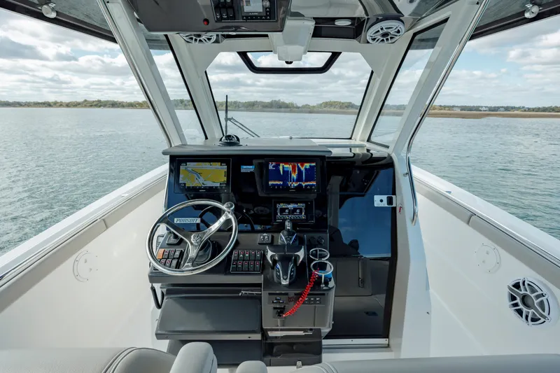 Slide: The Image of 2022 Pursuit S 328 boat cockpit with advanced navigation systems. - 37