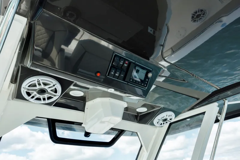 Slide: The Image of 2022 Pursuit S 328 boat interior with control panel and speakers. - 39