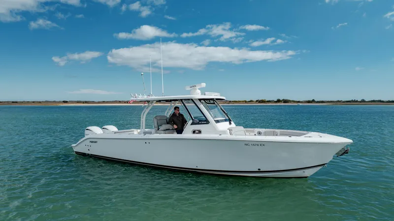 Slide: The Image of 2022 Pursuit S 328 boat on calm water with clear blue sky. - 4