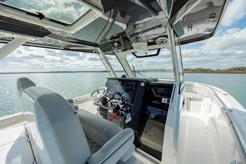 Slide: The Image of 2022 Pursuit S 328 boat interior with helm and seating. - 40