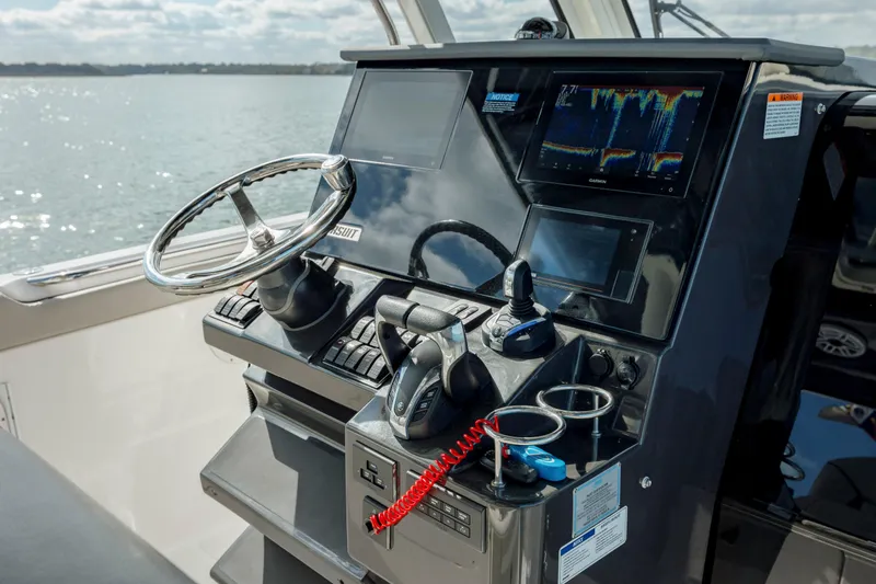 Slide: The Image of 2022 Pursuit S 328 boat helm with advanced navigation and control systems. - 41