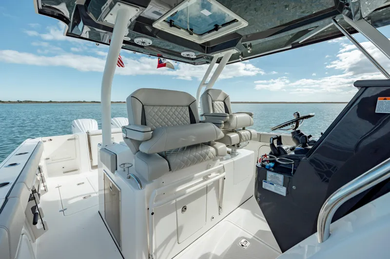 Slide: The Image of 2022 Pursuit S 328 boat interior with luxurious seating and modern controls. - 42