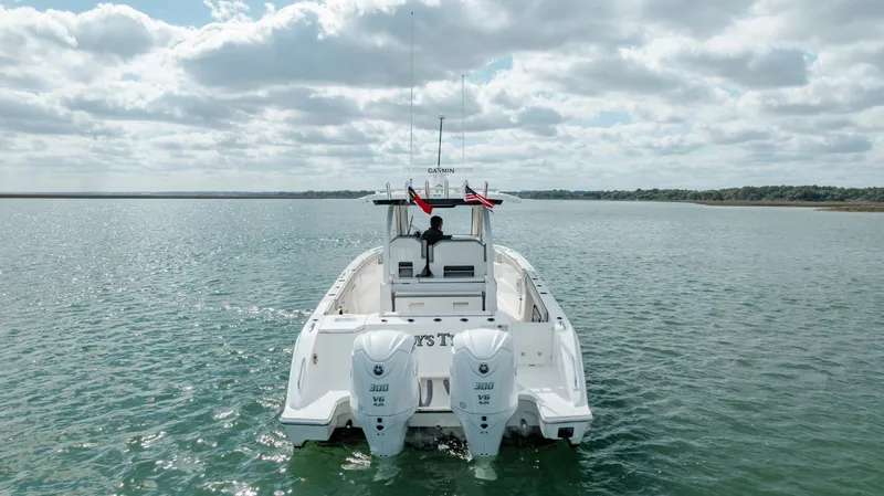 Slide: The Image of 2022 Pursuit S 328 boat on open water with twin engines. - 7