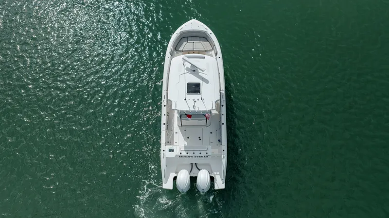 Slide: The Image of Aerial view of a 2022 Pursuit S 328 boat cruising on green water. - 8
