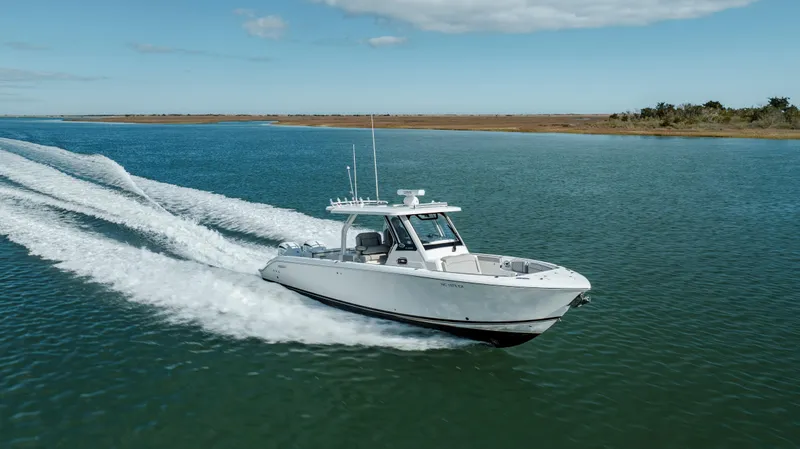 Slide: The Image of 2022 Pursuit S 328 boat cruising on open water. - 9