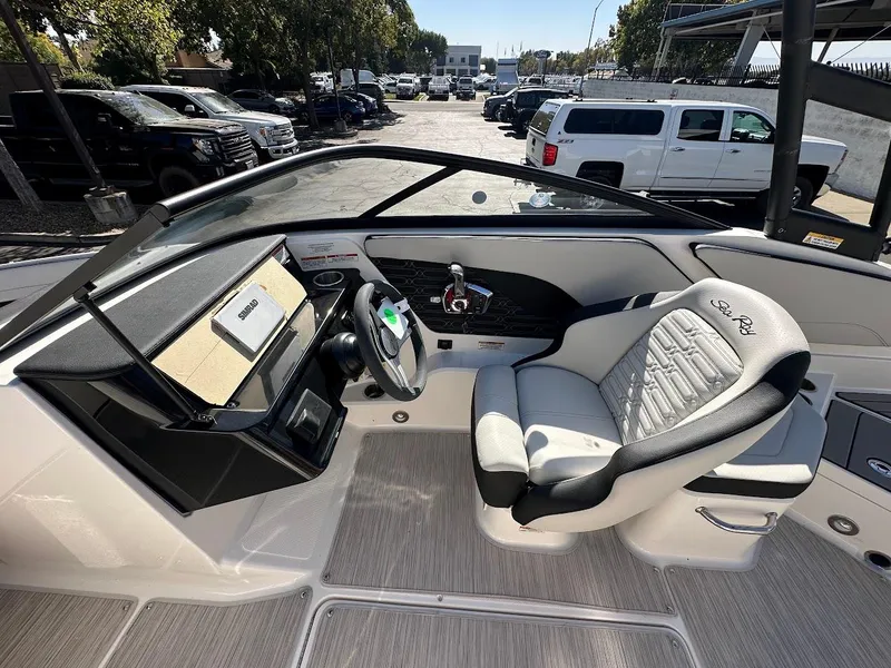 Slide: The Image of 2024 Sea Ray SPX 210 OB boat interior with modern dashboard and comfortable seating. - 12