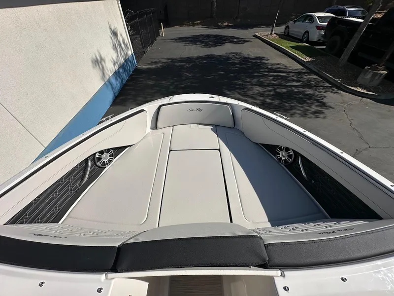 Slide: The Image of 2024 Sea Ray SPX 210 OB boat interior with cushioned seating and speakers. - 14