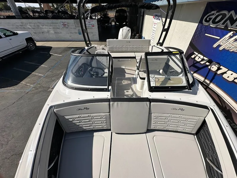 Slide: The Image of 2024 Sea Ray SPX 210 OB boat interior with seating and dashboard view. - 15