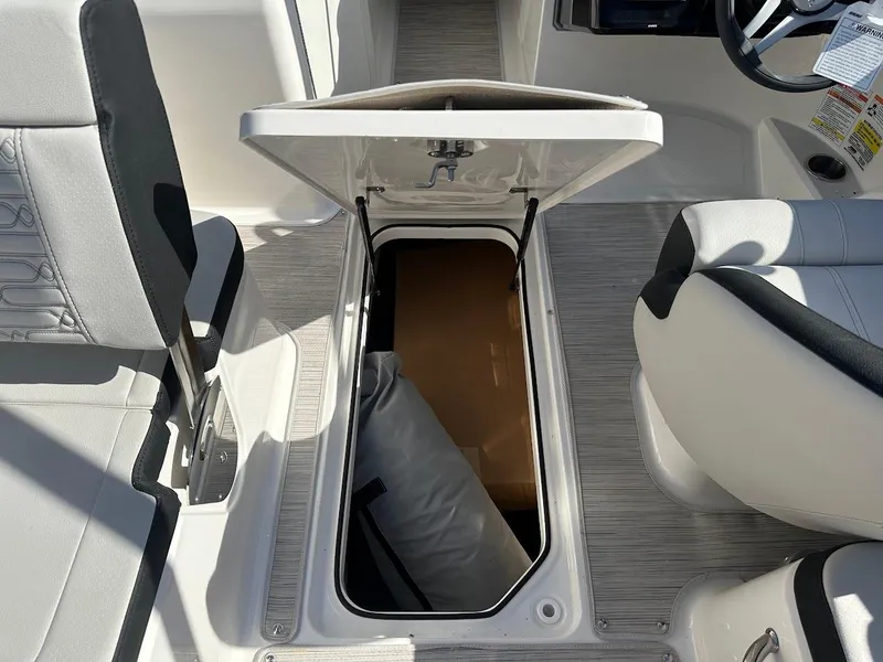 Slide: The Image of 2024 Sea Ray SPX 210 OB boat interior storage compartment open. - 16