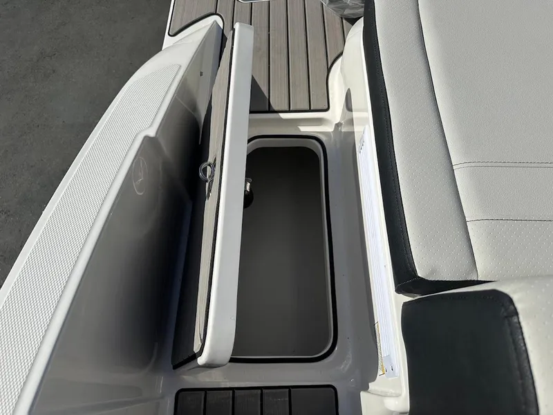 Slide: The Image of 2024 Sea Ray SPX 210 OB boat storage compartment with open lid. - 19