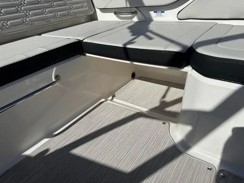Slide: The Image of 2024 Sea Ray SPX 210 OB boat interior with cushioned seating and modern design. - 20