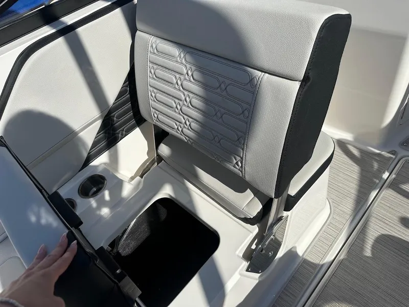Slide: The Image of 2024 Sea Ray SPX 210 OB boat seat with storage compartment open. - 21