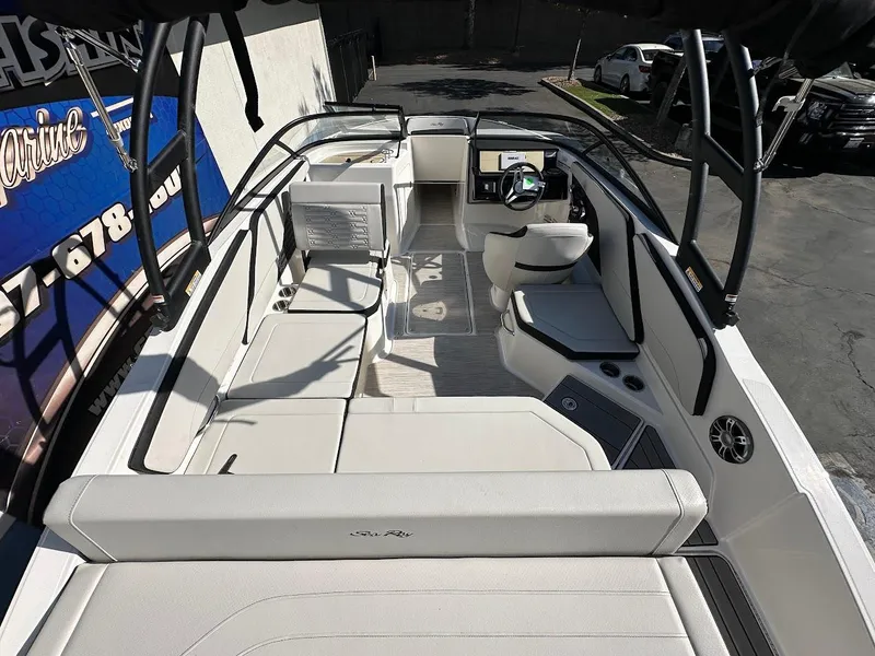 Slide: The Image of 2024 Sea Ray SPX 210 OB boat interior with spacious seating and modern dashboard. - 5