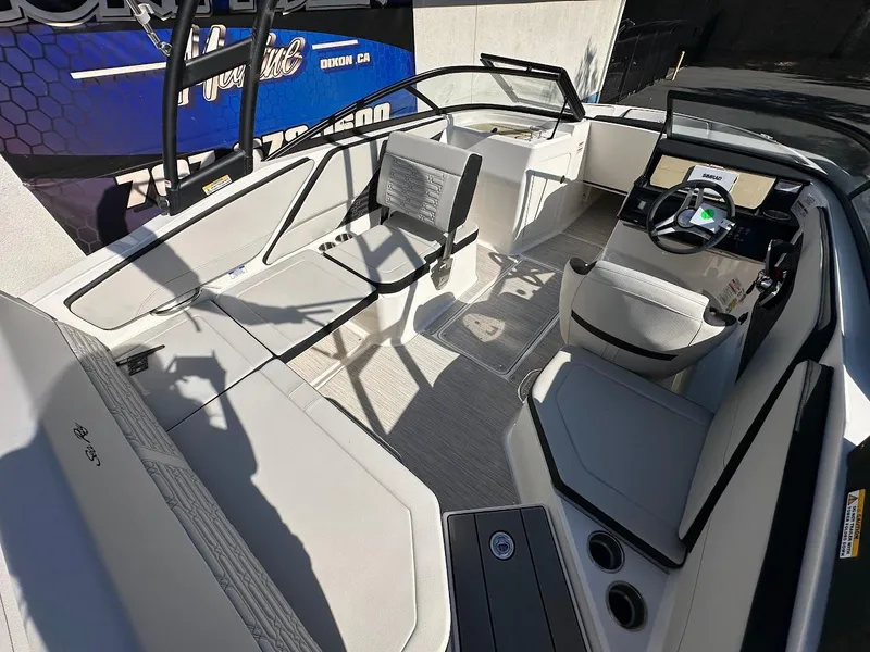 Slide: The Image of 2024 Sea Ray SPX 210 OB boat interior with modern seating and steering console. - 6
