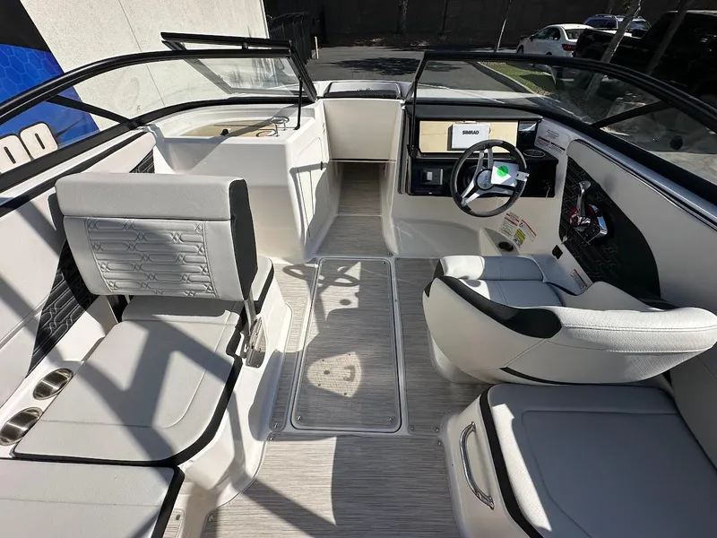 Slide: The Image of 2024 Sea Ray SPX 210 OB boat interior with modern seating and steering console. - 7