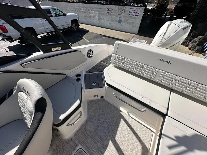 Slide: The Image of 2024 Sea Ray SPX 210 OB boat interior with white seating and modern design. - 9