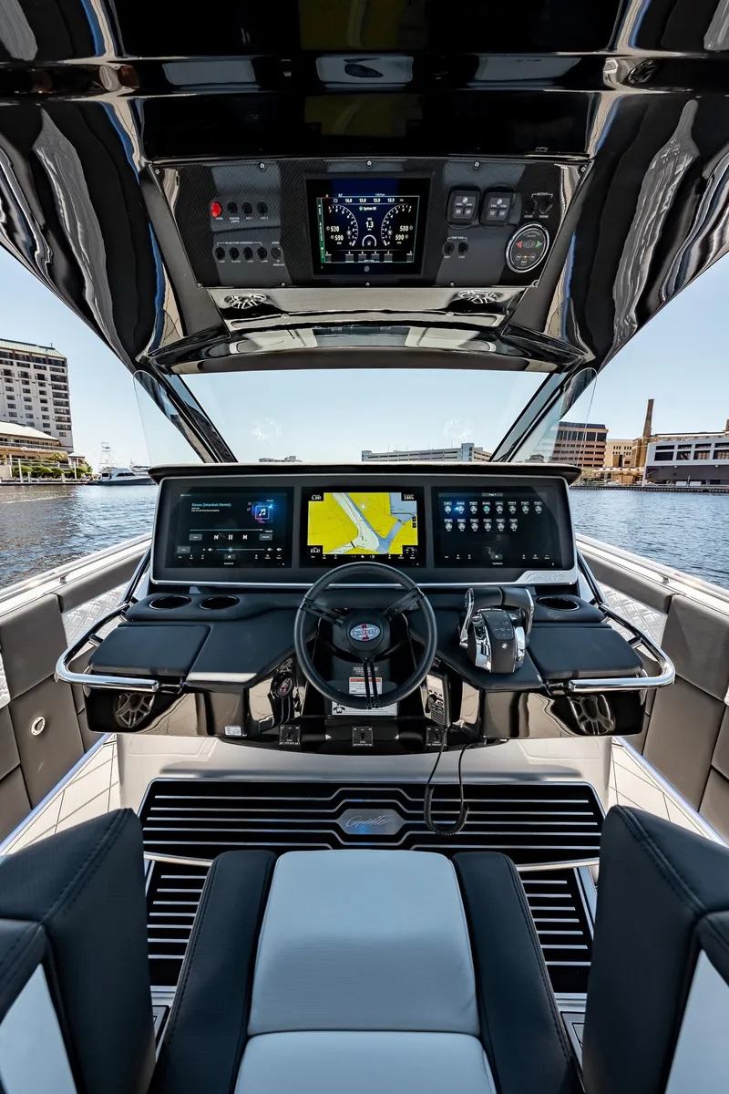 Slide: The Image of 2022 Cigarette 41 Nighthawk boat cockpit with advanced navigation system and waterfront view. - 11