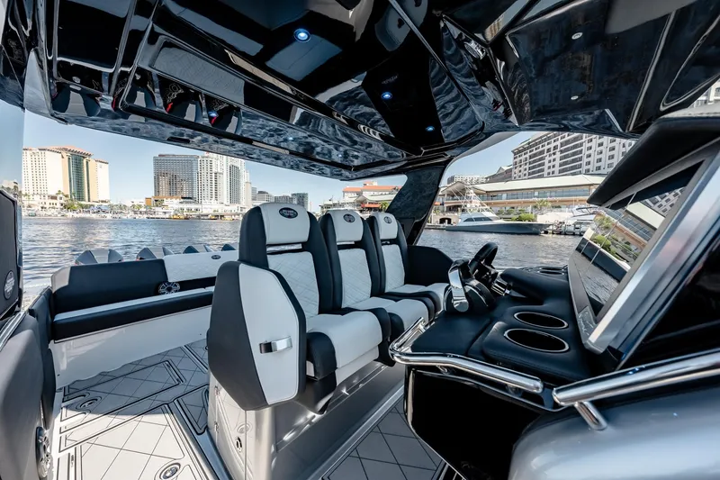 Slide: The Image of Interior of 2022 Cigarette 41 Nighthawk luxury powerboat with modern seating and waterfront view. - 12
