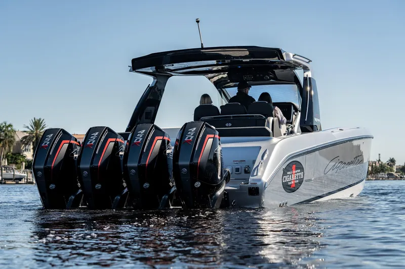 Slide: The Image of 2022 Cigarette 41 Nighthawk boat with quad outboard engines on water. - 3