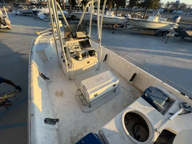 Slide: The Image of 1999 Sprint Pro Master 22 CC boat interior with console and cooler, docked at marina. - 10
