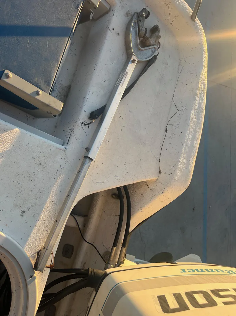 Slide: The Image of Close-up of a 1999 Sprint Pro Master 22 CC boat interior with a wrench and seat. - 16