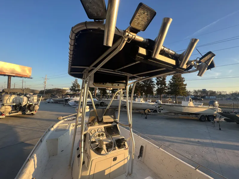 Slide: The Image of 1999 Sprint Pro Master 22 CC boat with T-top and fishing rod holders. - 4