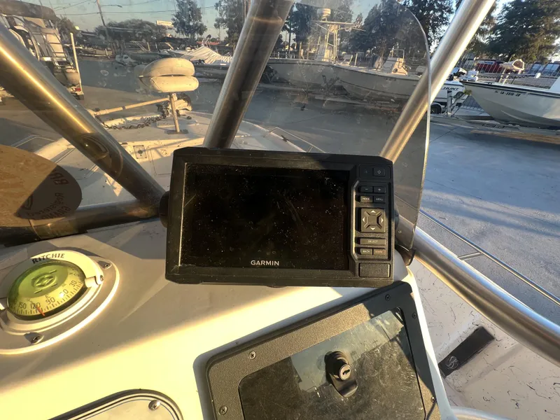 Slide: The Image of Garmin GPS and Ritchie compass on 1999 Sprint Pro Master 22 CC boat dashboard. - 6
