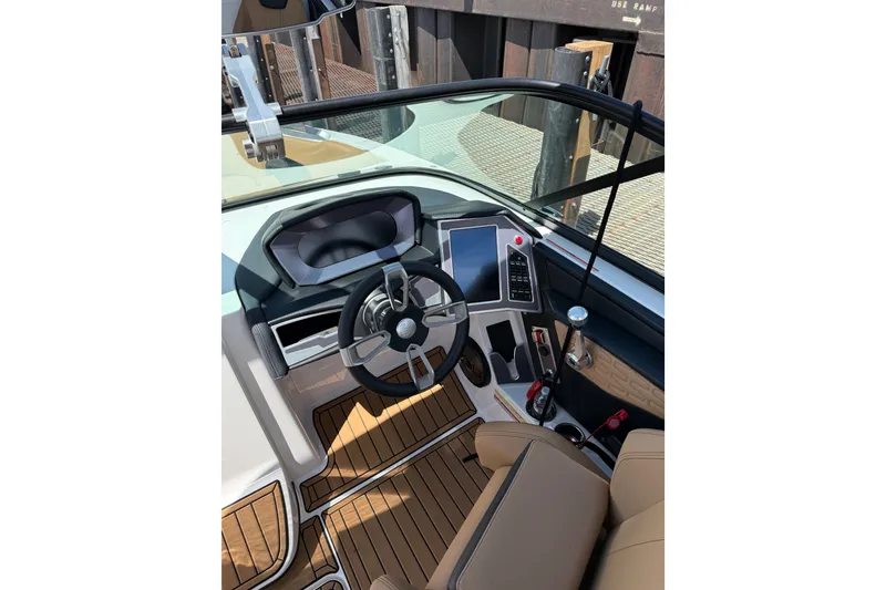 Slide: The Image of 2024 MasterCraft X26 boat cockpit with modern steering and controls. - 12