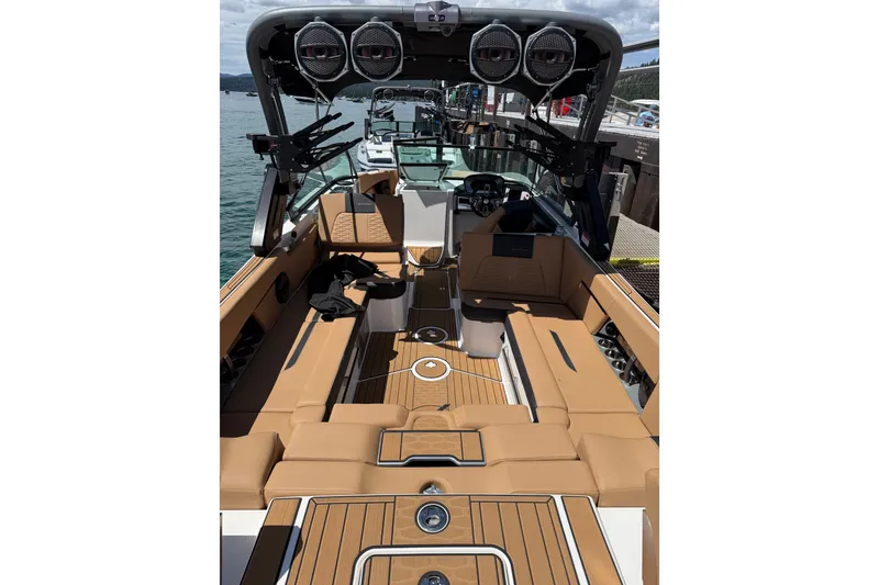 Slide: The Image of 2024 MasterCraft X26 boat interior with tan seating and advanced audio system. - 7