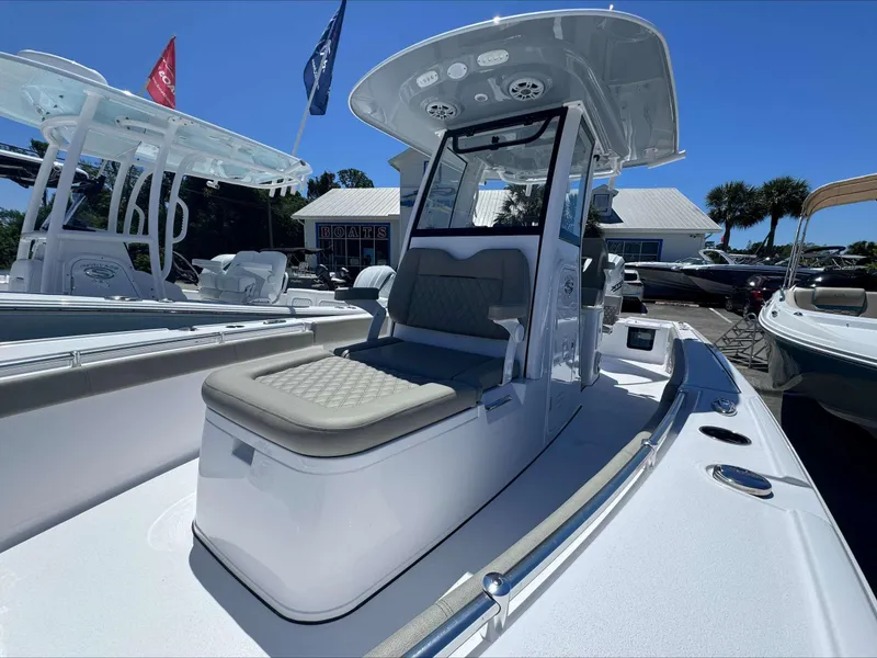 Slide: The Image of 2024 Sportsman 267 Masters OE boat with cushioned seating and T-top in a dealership. - 5