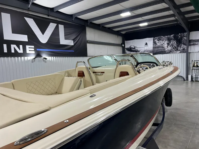 Slide: The Image of 2023 Chris-Craft Launch 27 boat in showroom, featuring elegant interior and sleek design. - 12