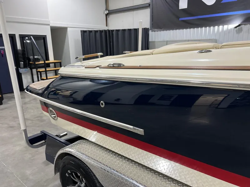 Slide: The Image of 2023 Chris-Craft Launch 27 boat on trailer in indoor showroom. - 14