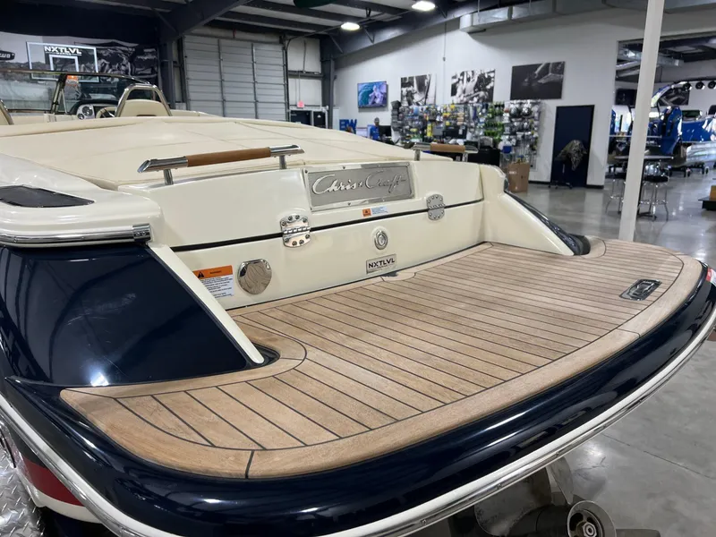 Slide: The Image of 2023 Chris-Craft Launch 27 boat with teak swim platform in showroom. - 16