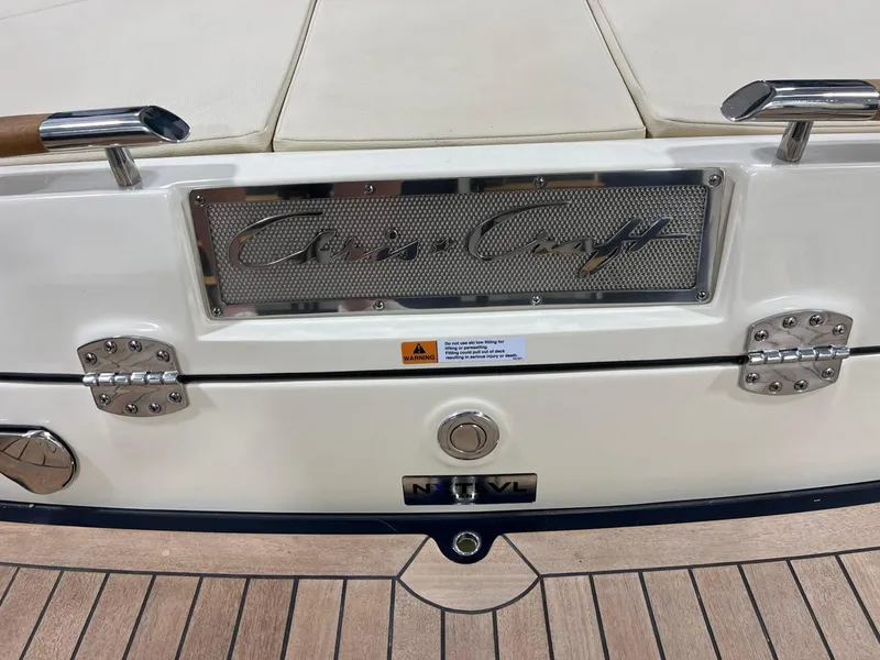 Slide: The Image of 2023 Chris-Craft Launch 27 boat stern with logo and teak deck. - 21