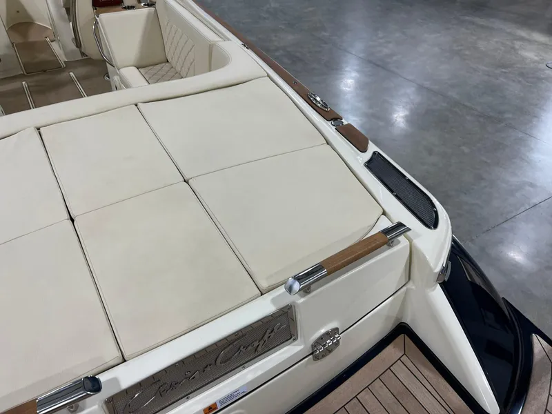 Slide: The Image of 2023 Chris-Craft Launch 27 boat interior with beige seating and wooden accents. - 22