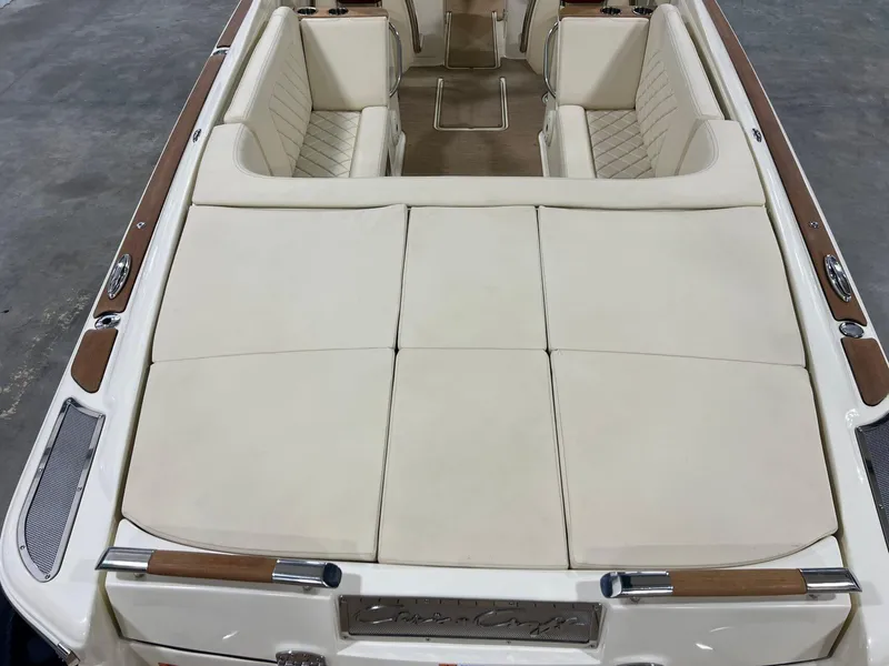 Slide: The Image of 2023 Chris-Craft Launch 27 boat interior with beige seating and wood accents. - 24