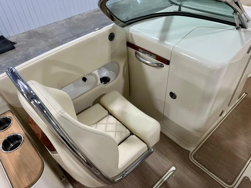 Slide: The Image of 2023 Chris-Craft Launch 27 interior with beige seating and wood accents. - 28