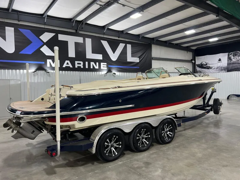 Slide: The Image of 2023 Chris-Craft Launch 27 boat on trailer in indoor showroom. - 3