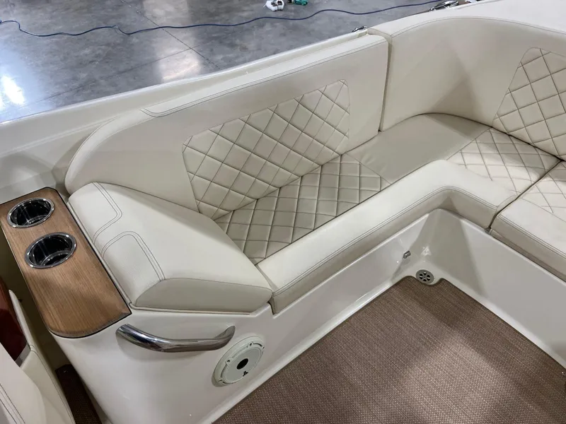 Slide: The Image of Luxurious seating in 2023 Chris-Craft Launch 27 boat with quilted upholstery and cup holders. - 30