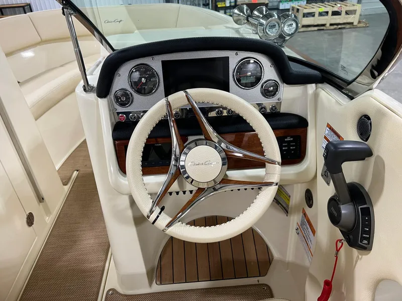 Slide: The Image of 2023 Chris-Craft Launch 27 boat dashboard with steering wheel and control panel. - 31