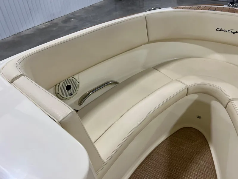 Slide: The Image of 2023 Chris-Craft Launch 27 boat interior with cream leather seating and speaker. - 36