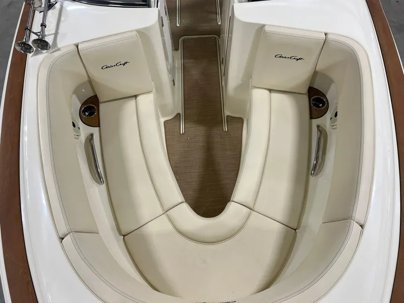 Slide: The Image of 2023 Chris-Craft Launch 27 boat interior with cream seating and wood accents. - 38
