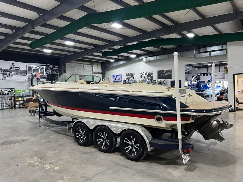Slide: The Image of 2023 Chris-Craft Launch 27 boat in showroom, on trailer, side view. - 5