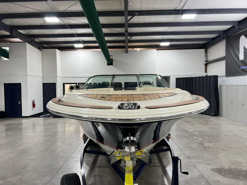 Slide: The Image of 2023 Chris-Craft Launch 27 boat in a showroom, showcasing sleek design and craftsmanship. - 9