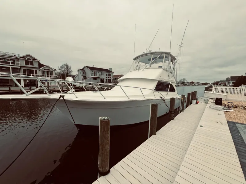 Slide: The Image of 2002 Egg Harbor 42 Sport Fish yacht docked at a marina. - 10