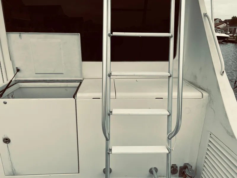 Slide: The Image of Egg Harbor 42 Sport Fish 2002 boat ladder and storage compartments. - 14