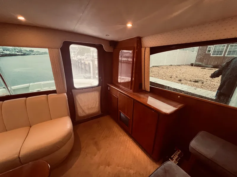 Slide: The Image of Interior of 2002 Egg Harbor 42 Sport Fish yacht with beige seating and wooden cabinetry. - 20