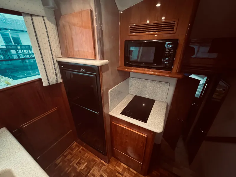 Slide: The Image of Interior kitchen of 2002 Egg Harbor 42 Sport Fish yacht with microwave, stove, and refrigerator. - 23