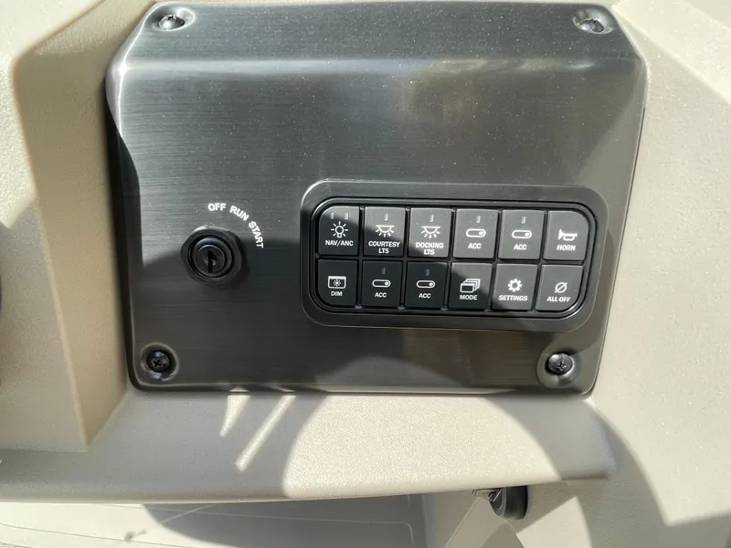 Slide: The Image of Control panel of 2024 Sun Tracker Party Barge 24 DLX with various switches. - 5