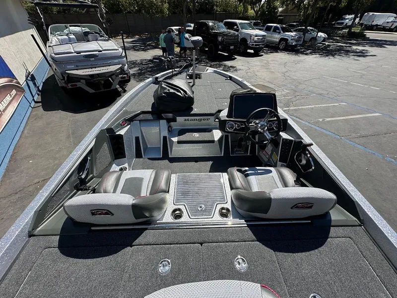 Slide: The Image of 2024 Ranger Z519 boat interior with seating and control panel in a parking lot. - 12